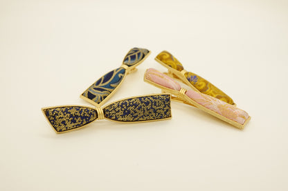 Silk bow hair clips in navy and gold and pink silk patterns
