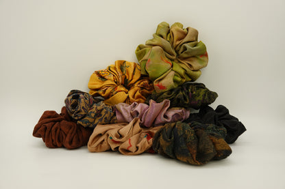 A collection of handmade silk scrunchies in assorted colours and patterns